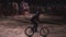 Real time video of extreme athlete man doing an amazing trick on the MTB Bmx bike while dirtjumping at night at the