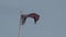 Real Union Jack flag of the United Kingdom on flagpole fluttering in the wind