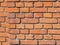 Real wall of red and orange bricks