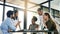 Realising their collective goal. Shot of a group of colleagues working together in an office.