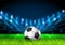 Realistic 3D Soccer ball on the grass football field with bright stadium lights. Football Arena. Vector illustration for