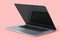 Realistic aluminum laptop with empty white screen isolated on pink background.