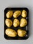 realistic baked potatoes black background long shot