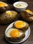 Realistic baked potatoes neutral palette warm lighting.