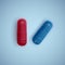 Realistic capsule and a pill on a white background, medicine, red capsule and white tablet, vector illustration