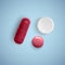Realistic capsule and a pill on a white background, medicine, red capsule and white tablet, vector illustration