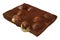Realistic chocolate bar piece with whole hazelnuts