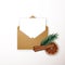Realistic craft envelope with winter decor fir tree branch, cinnamon, orange slice.