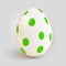 Realistic Easter egg with green spot pattern.