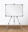 Realistic empty whiteboard standing on tripod in the room with wooden floor vector illustration