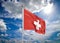 Realistic flag. 3D illustration. Colored waving flag of Switzerland on sunny blue sky background