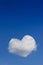 Realistic Heart shaped cloud in the blue sky