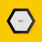 Realistic hexagon picture frame isolated on yellow wall background.