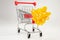 Realistic iron mini shopping cart with plastic parts with a silver Christmas bow. Object for purchases such as sales