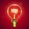 Realistic lamp with the inscription of 2020 year instead of the filament of incandescence, isolated on a red background