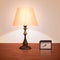 Realistic night lamp or floor lamp standing on a table or bedside table with a clock.