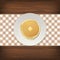 Realistic pancake with a piece of butter on a white plate closeup on wood background, top view. Design template for