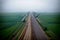 Realistic photo bird view of the empty highway through the fields in a fog