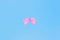 Realistic pink ribbon, bow on a blue background, the concept of a holiday card