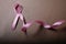 Realistic pink ribbon, breast cancer awareness symbol.