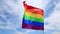 Realistic rainbow flag of an LGBT organization waving against a blue sky. LGBT pride flags for lesbians, gays, bisexuals