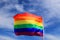 Realistic rainbow flag of LGBT organization waving against sky. LGBT pride flags include lesbians, gays, bisexuals and transgender