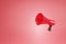Realistic red megaphone or bullhorn speaker Isolated modern megaphone speaker on red background - 3D rendering
