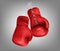 Realistic red pair of leather boxing gloves with lacing