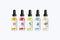 Realistic set bottles mock up with tastes for an electronic cigarette with different fruit flavors. Dropper bottle with