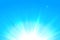 Realistic sun and sunbeams on blue sky. Abstract summer sunny sky. Vector background of daytime sunny sky with bokeh