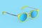 Realistic sunglasess with gradient lens and blue plastic frame on blue