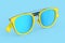 Realistic sunglasess with gradient lens and blue plastic frame on blue