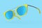 Realistic sunglasess with gradient lens and blue plastic frame on blue