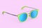 Realistic sunglasess with gradient lens and green plastic frame on pink