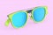 Realistic sunglasess with gradient lens and green plastic frame on pink