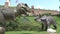 Realistic two big dinosaurs they look at each other in dino park