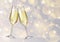 Realistic vector illustration of champagne glasses on blurred holiday silver sparkle background