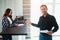 Realtor, broker or landlord shows an apartment to a young woman. She is going to sign a lease agreement with him.