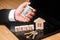 The realtor`s hand holds a bundle of money near the house with the keys. Sale of apartments and houses. Sale of property, realtor