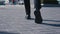 Rear back view feet of businessman commuting to work. Confident guy in leather shoes and suit being on his way to office