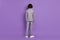 Rear back view photo of anonymous incognito pupil schoolboy guy wear grey suit isolated violet color background