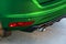 Rear bumper of a green car with exhaust pipe, modern car exterior details.