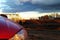 Rear car light and dew drop on, view in the morning while car parking with sunshine on grass background.