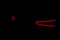 Rear car lights on a black background. Cars light trails. Night city road with traffic headlight. Light up road by vehicle. Car li