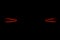 Rear car lights on a black background. Cars light trails. Night city road with traffic headlight. Light up road by vehicle. Car li