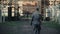 A rear close view of a German soldier walking slowly to the gate of a blurred concentration camp reconstruction. Slow