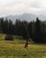 Rear of a girl putting a hand on the hat cloudy High Tatras mountain background