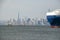 Rear of huge vessel in front of hazy Manhattan Skyline, New York City