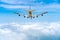 Rear image commercial passenger aircraft or cargo transportation airplane flying over white fluffy cloud with blue sky and spread