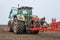 Rear of a modern tractor with a trailing unit for sowing